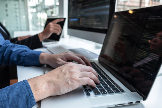 Professional Team of programmer working on project in software development computer in IT company office, Writing codes and data code website and coding database technologies on new Application