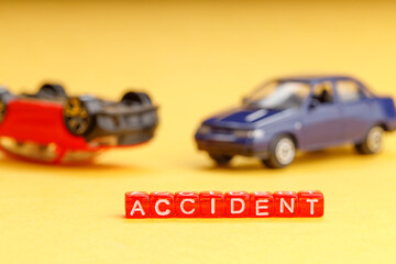 toy car crash on yellow background close-up out of focus blurred