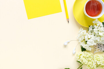 Top view of home office desk with with notepad, pencil , cup of hot tea