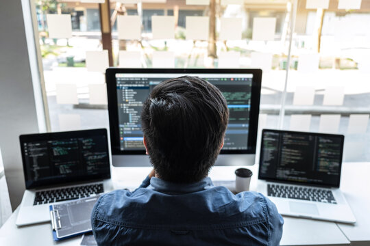 Developer programmer working on project in software development computer in IT company office, Writing codes and data code website and coding database technologies to find solution to problem
