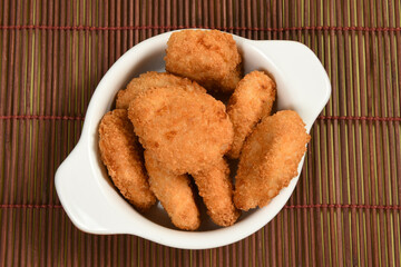 A portion of breaded chicken in a ceramic bowl