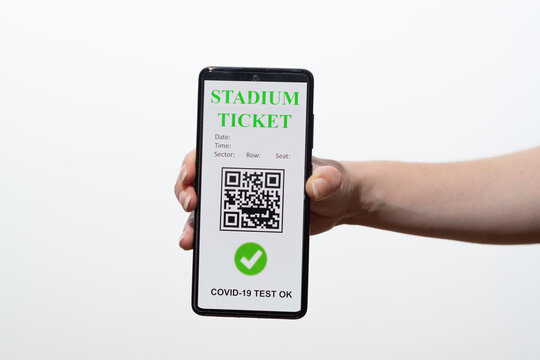 vaccinated person using digital health passport app in mobile phone to show stadium ticket during covid-19 pandemic
