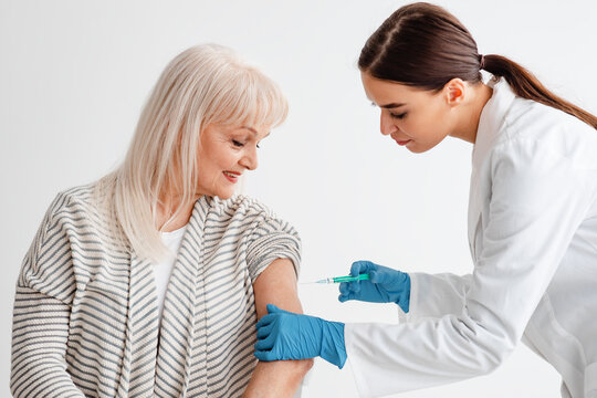 Smiling Senior Lady Receiving Coronavirus Vaccine Intramuscular Injection