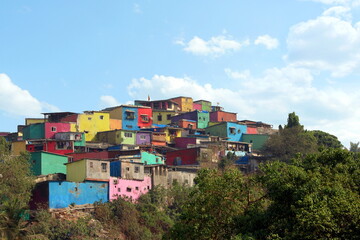 Asalpha hilltop  with a line of colorful slums, Ghatkopar, Mumbai, Maharashtra. Deepya Reddy, Chal...