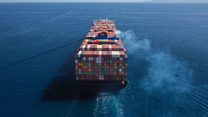 Aerial drone photo of huge container carrier tanker ship cruising deep blue open ocean sea - obrazy, fototapety, plakaty