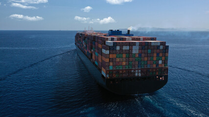 Aerial drone photo of huge container carrier tanker ship cruising deep blue open ocean sea © aerial-drone