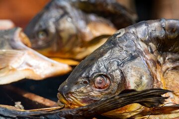 heads of smoke-smoked fish stacked in rows