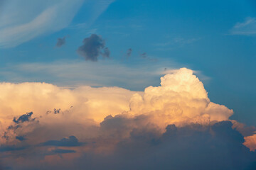 evening sky with beautiful sunlit clouds as a natural background