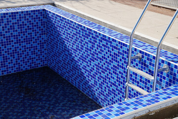 Fototapeta premium empty pool without water with stairs on a sunny day