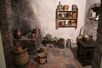 In the village room there are old wooden buckets, old copper dishes and clay jugs