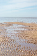 prints of waves, traces of water in the sand.