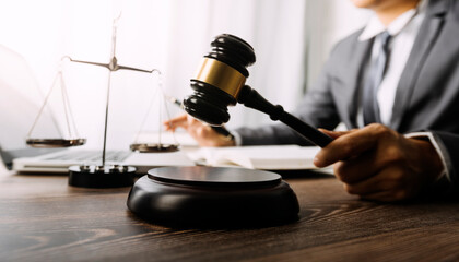 justice and law concept.Male judge in a courtroom on wooden table and Counselor or Male lawyer...
