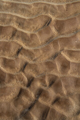 prints of waves, traces of water in the sand.