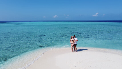 Mature couple on vacation hugging on a tropical beach