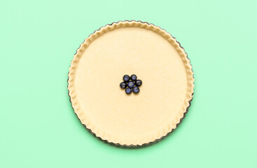 Obraz na płótnie Canvas Pie crust and blueberries in a tray, top view. Baking blueberry pie with pastry dough