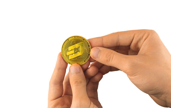 Man holds one Dash coin in hand isolated on white background, crypto currency blockchain coin dash symbol photo