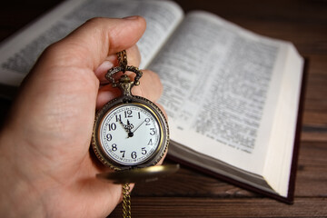 a pocket watch in the hands of a man