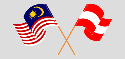 Crossed and waving flags of Malaysia and Austria