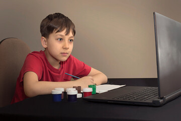 boy in an online paint drawing lesson. creativity. Online School Distance Learning Concept