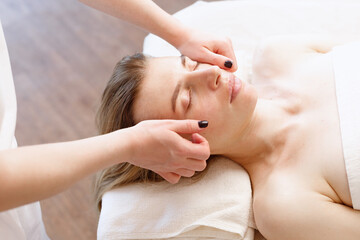 Obraz na płótnie Canvas woman on facial massage in spa salon