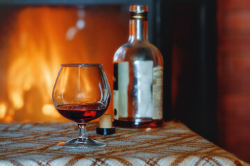 a glass of sweet wine by the light of the fireplace. late evening