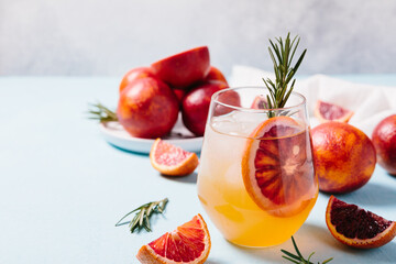 Delicious Blood Orange Gin Cocktail on light blue background. Summer cocktails, refreshing drinks,...