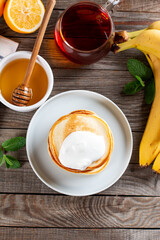 Pancakes. Stack of pancakes with sour cream. Tasty breakfast food on a table. Top view