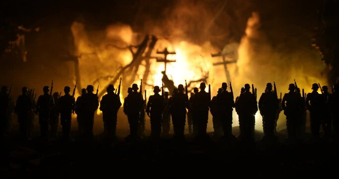 War Concept. Military silhouettes fighting scene on war fog sky background, World War Soldiers Silhouette Below Cloudy Skyline At night. German soldiers in ranks. Selective focus
