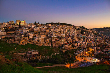 Obraz premium Old city. East quarter. Muslim Quarter, panoramic top view at blue hour at sunset.
