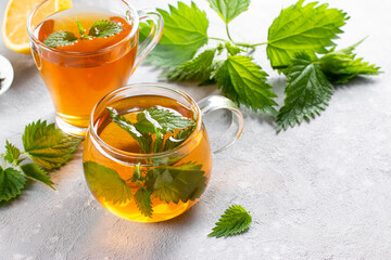 Nettle tea in glass. Fresh and dry nettle. Copy space