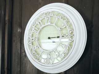 White clock on the wall. The hands show the time 4:15 p.m.