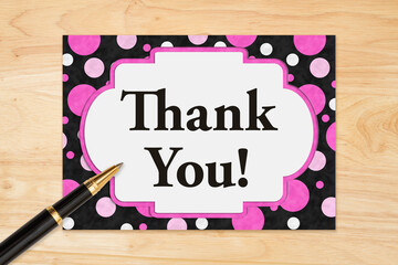 Thank You message on a greeting card on wood desk