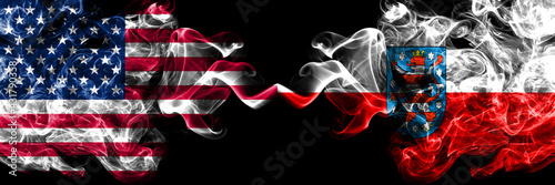 United States of America, America, US, USA, American vs Geremany Thuringia, state smoky mystic flags placed side by side. Thick colored silky abstract smoke flags.