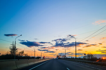 Highway at sunset. View of asphalt road from the car window.