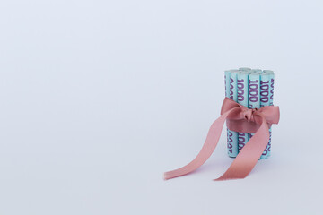 Money gift. Ukrainian hryvnia in a roll. Copy space.