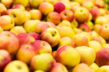 Bunch of green and red apples on boxes in supermarket