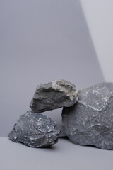 Naklejka premium Gray stones on a gray background. Monochrome background.