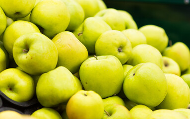 Bunch of green and red apples on boxes in supermarket