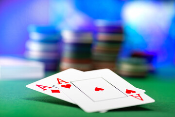 Two aces and stack of Casino Chips in background