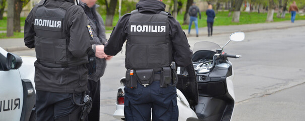 Patrol policemen. Ukraine. Word Police in Ukrainian on the the policemens' uniform. 
