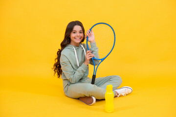 be hydrated. kid sit with racket and water bottle. child with tennis racquet.