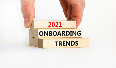 2021 onboarding trends symbol. Wooden blocks with words '2021 onboarding trends' on beautiful white background. Businessman hand. Business and 2021 onboarding trends concept. Copy space.