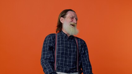 Happy joyful senior old bearded gray-haired man laughing out loud after hearing ridiculous anecdote, funny joke, feeling carefree amused, positive people lifestyle. Elderly grandfather pensioner