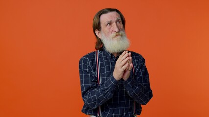 Sneaky cunning mature bearded grandfather with tricky face gesticulating and scheming evil plan,...