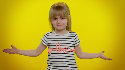 Confused mad blonde child girl raising hands in indignant expression, asking why, what reason of...