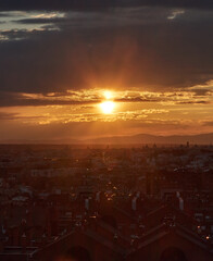 Panoramic of the city under the golden light of the setting sun. Vertical view.