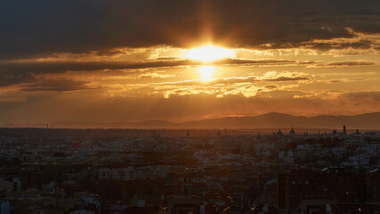 Panoramic of the city under the golden light of the setting sun. Horizontal view.