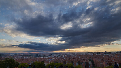 wide angle view of the city with buildings and the sky with a dark cloud