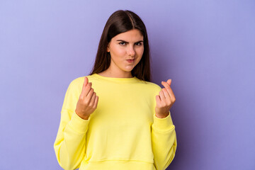 Young caucasian woman isolated on purple background showing that she has no money.