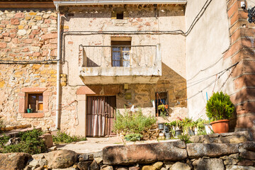 Fototapeta na wymiar facade of traditional old houses made of stone decorated with plants and flowers